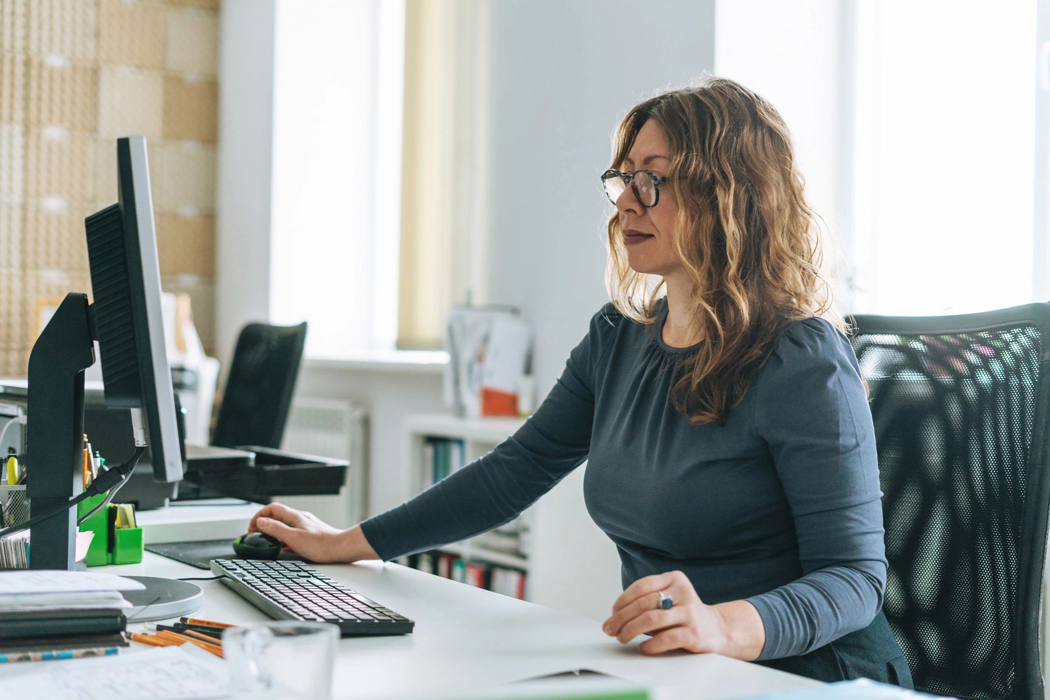 Administrator working at a computer in a modern office