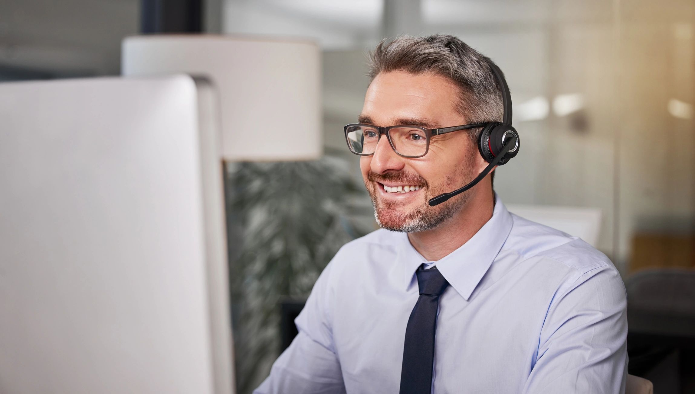 Call centre agent wearing a headset, representing responsive customer support.