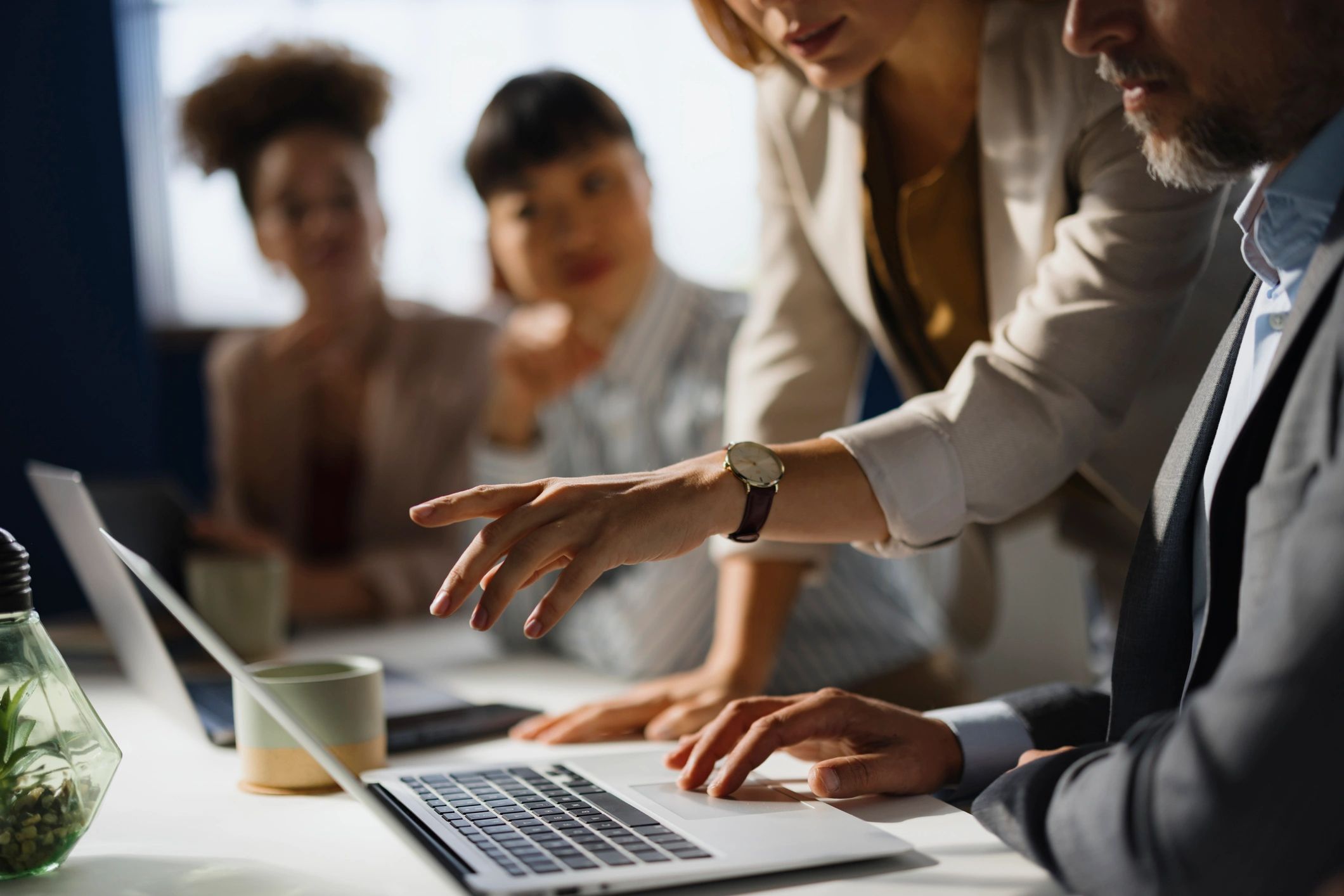 Team reviewing back-office workflow on a computer in an office