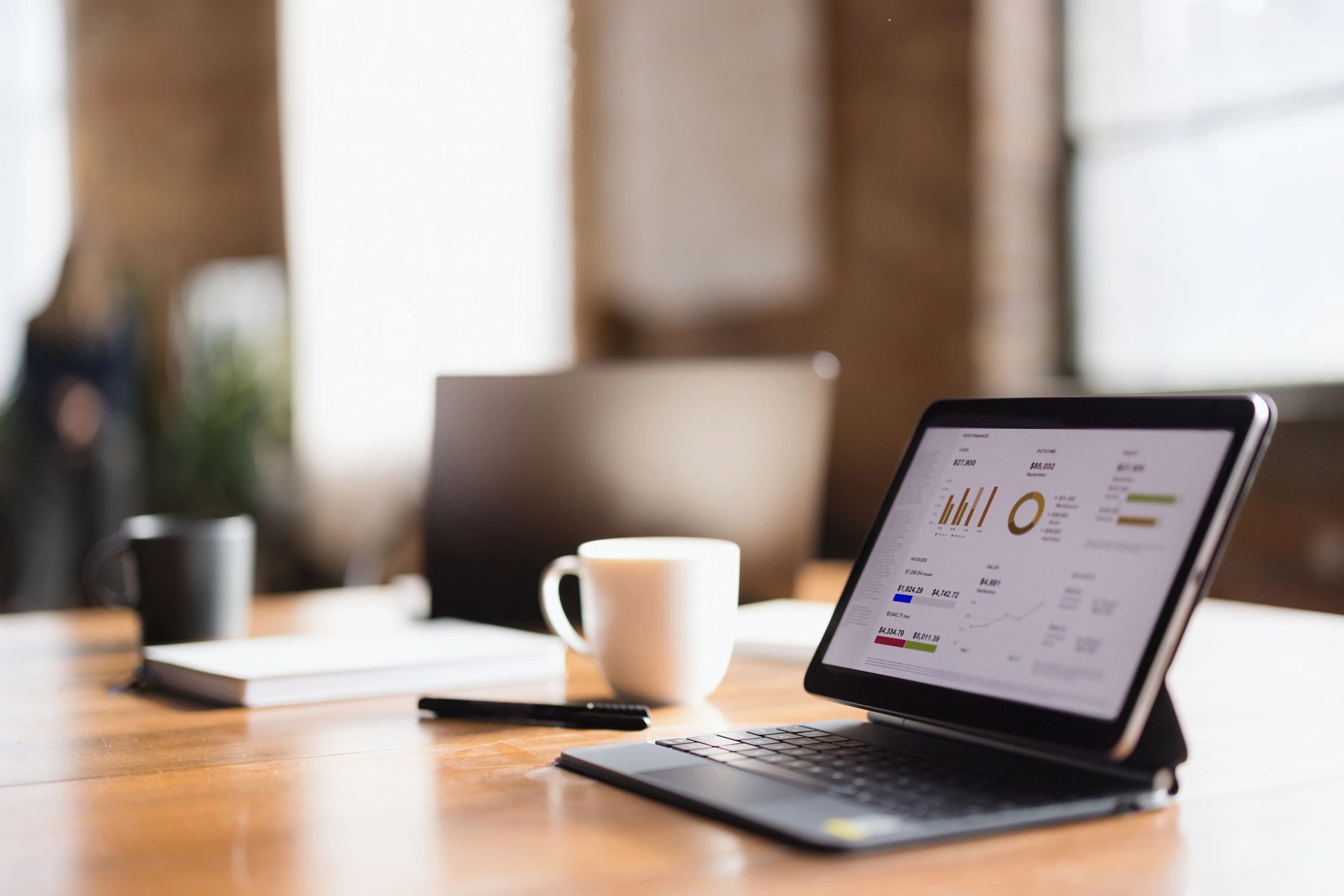 Business performance dashboard on a tablet, representing order-to-cash reporting and cashflow visibility.